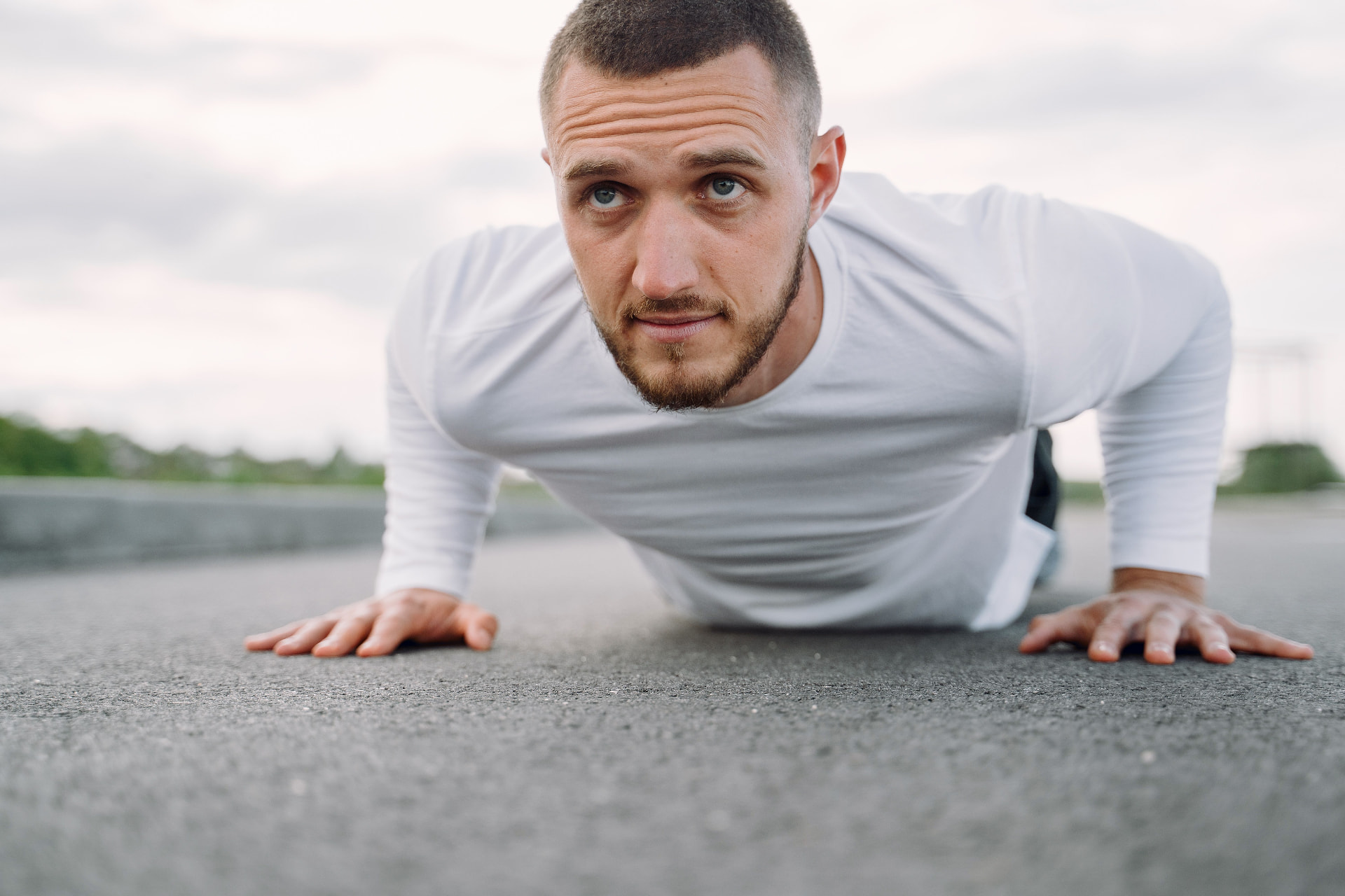 Man doing push-ups outdoors, focused